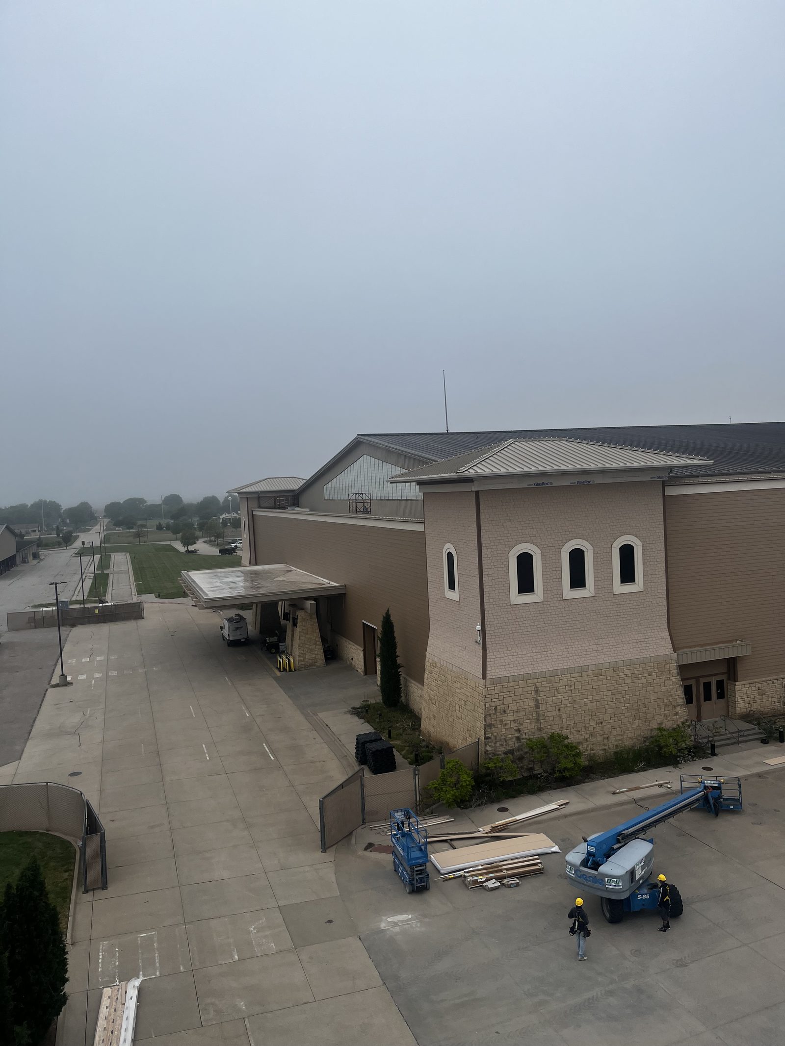 Commercial job site with crew and lifts