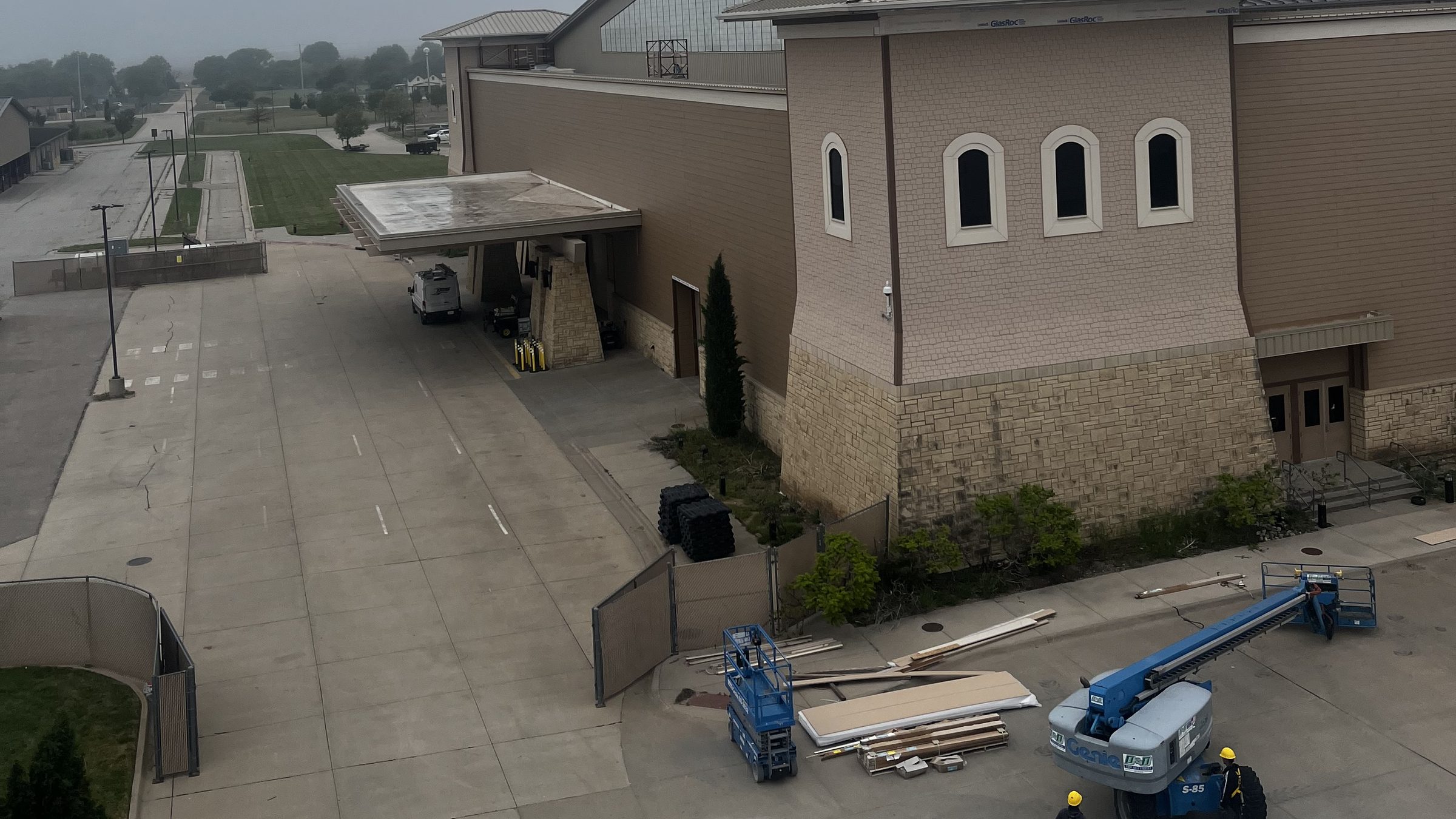 Commercial job site with crew and lifts