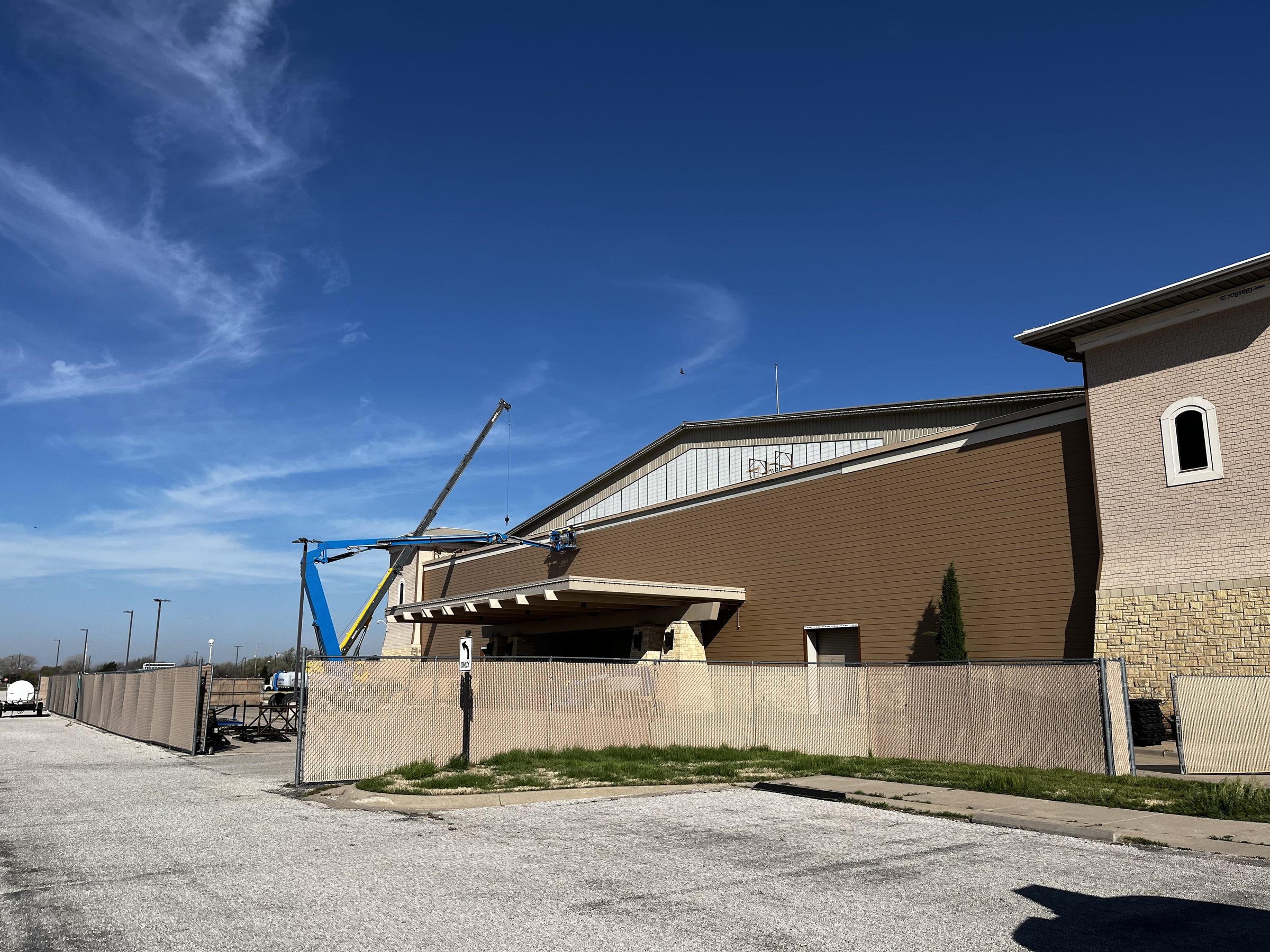 Commercial exterior siding work with boom lift