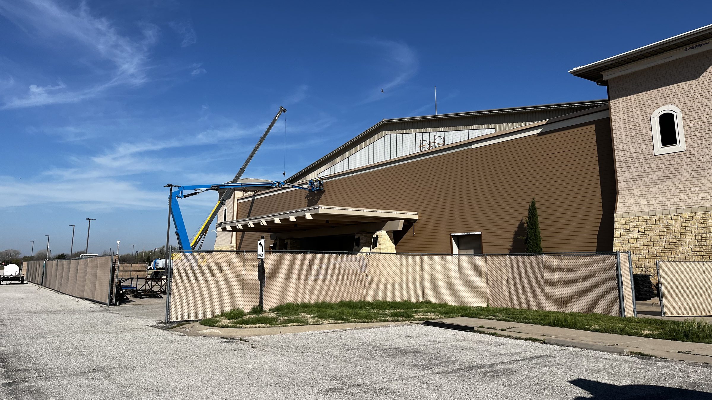 Commercial exterior siding work with boom lift