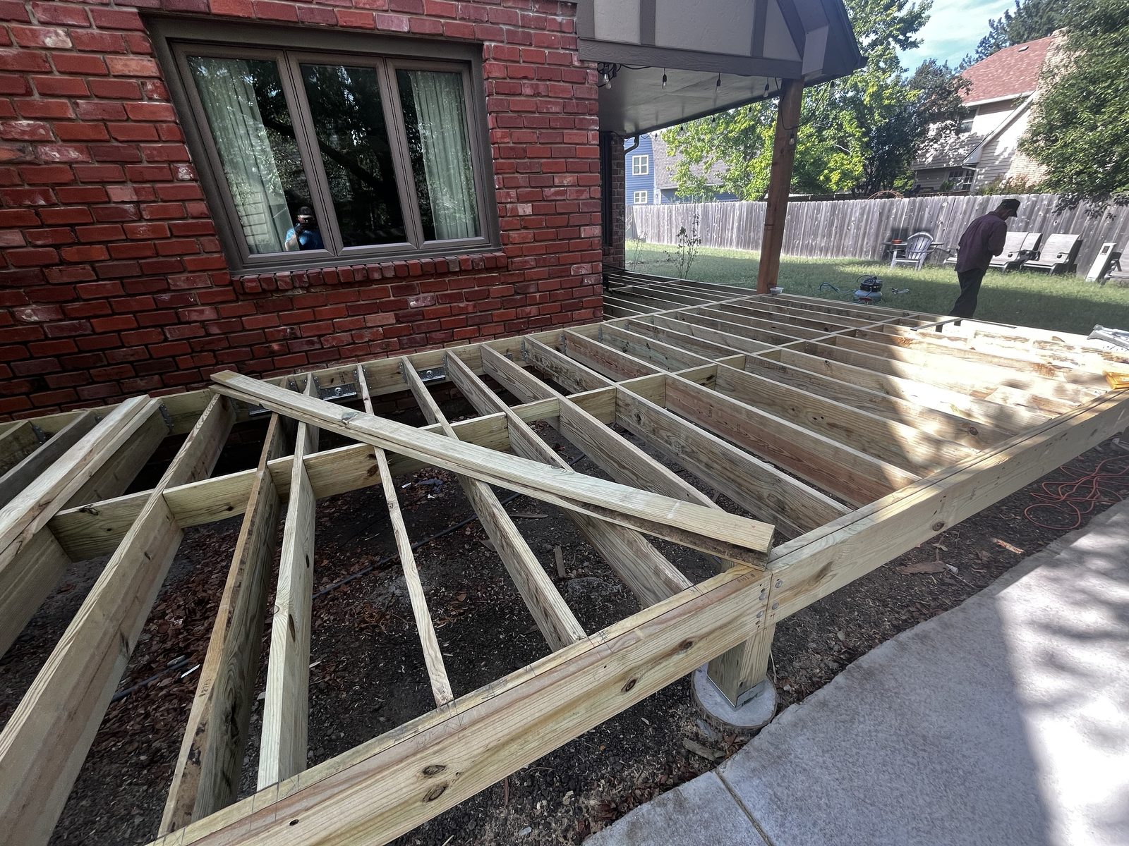 Pressure-treated deck framing with joist hangers