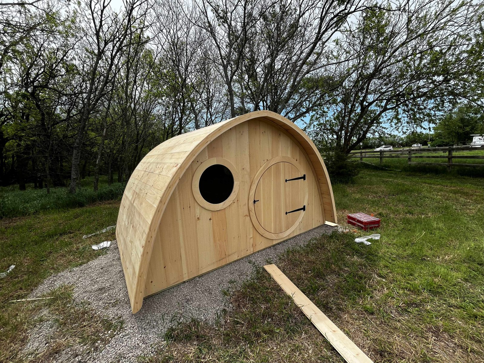 Finished custom hobbit house with round door and porthole window
