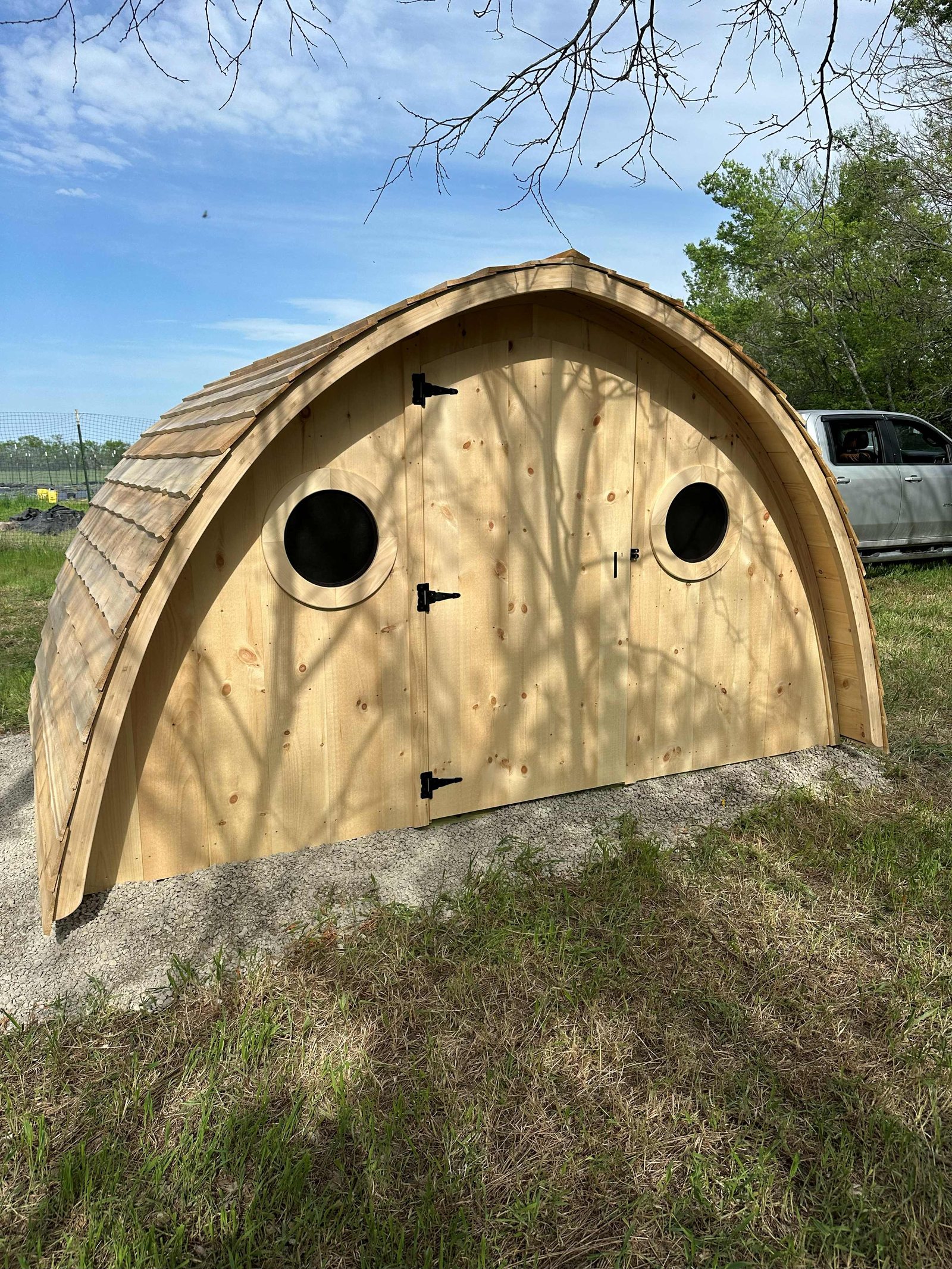 Front elevation with twin portholes and cedar shingles