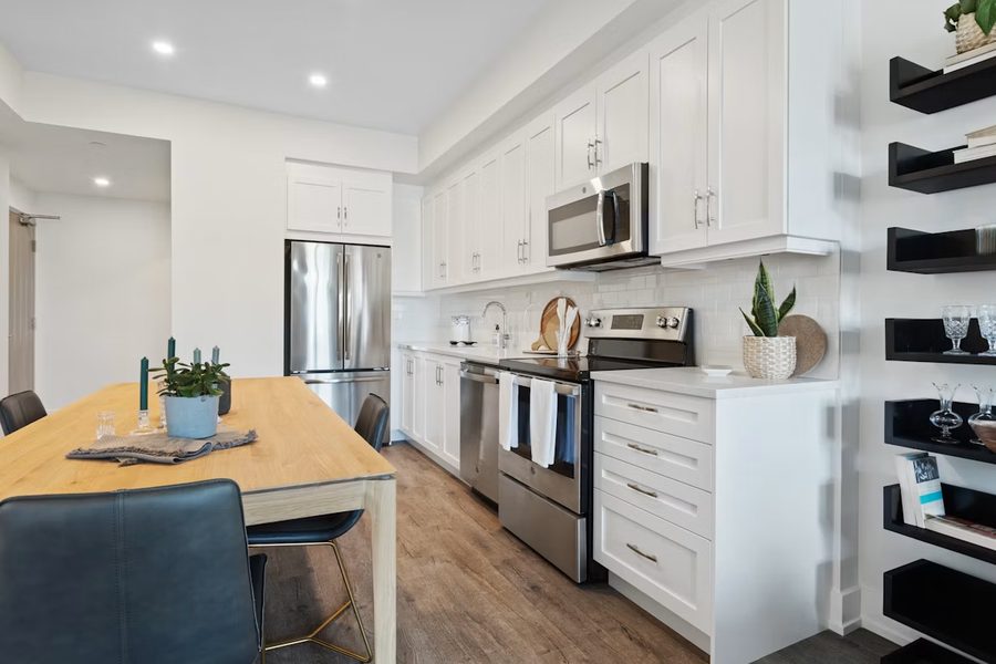 Finished kitchen with white cabinets and stainless appliances