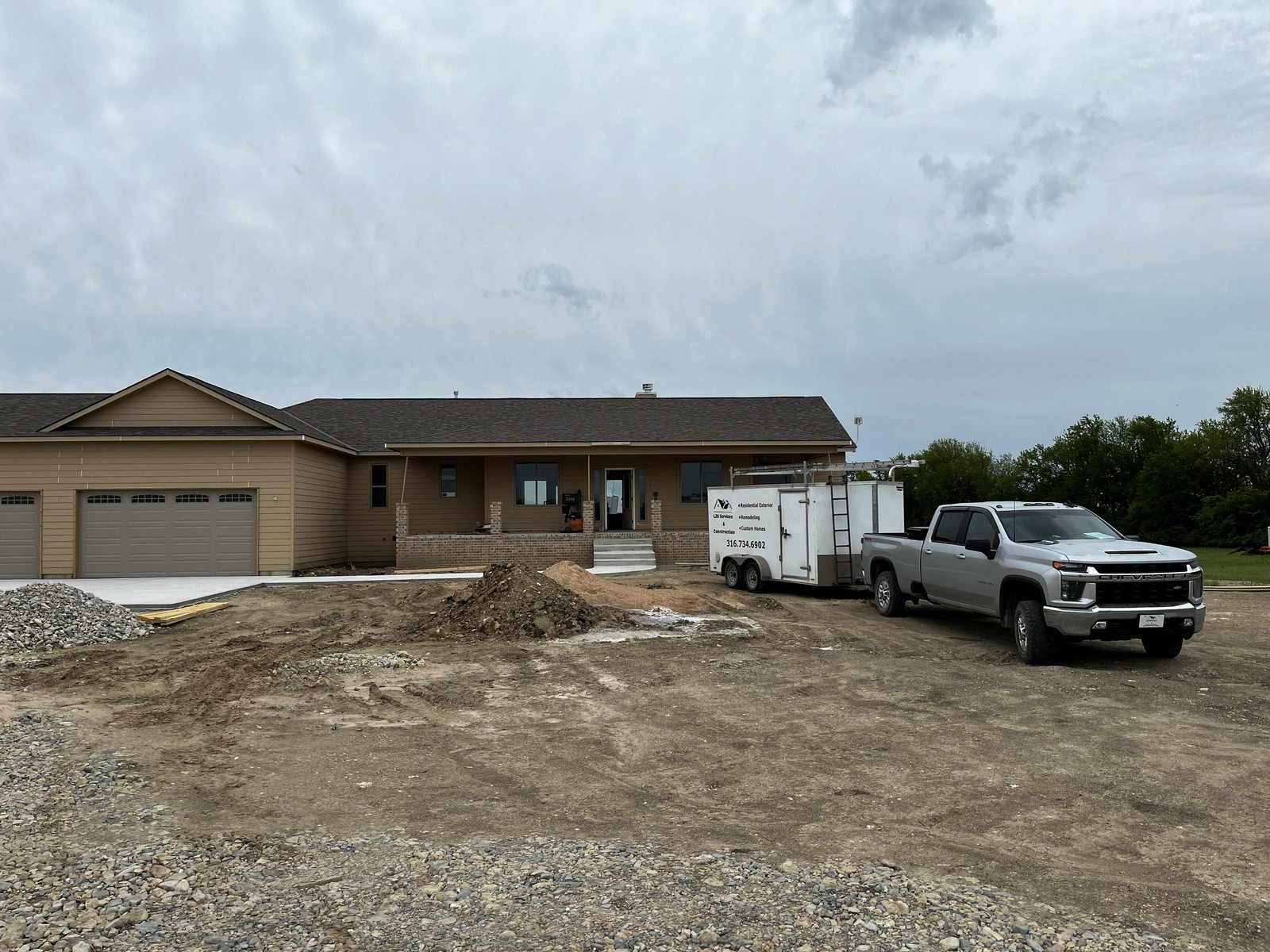New construction exterior with our truck and trailer on site